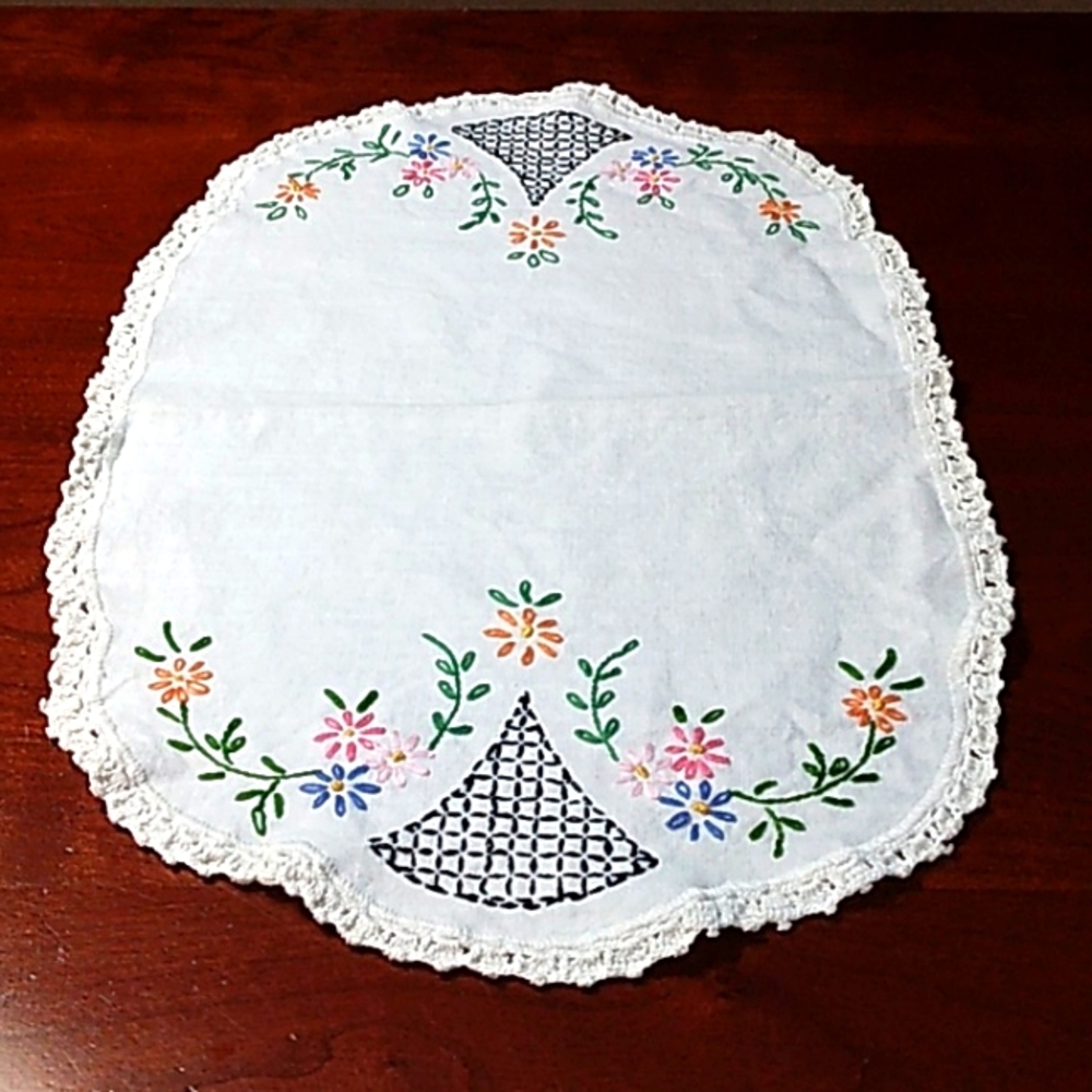 Vintage hand stitched linen table scarf with delicately colored flowers.